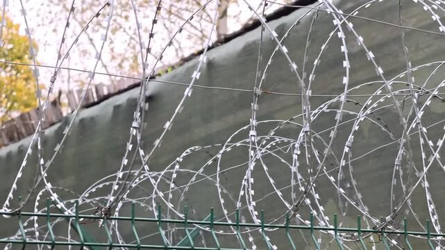 Close up of a barbed wire fence, often used as a border or enclosure