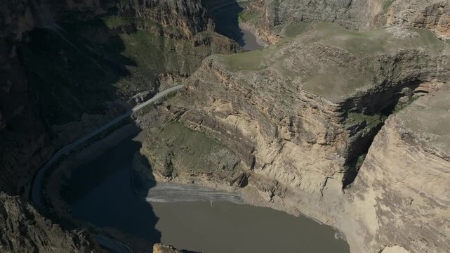 Scenic aerial footage captures the dramatic confluence of mountain rivers forming the Sulak River near Gimry in the Republic of Dagestan, Russia with steep rocky canyon cliffs around