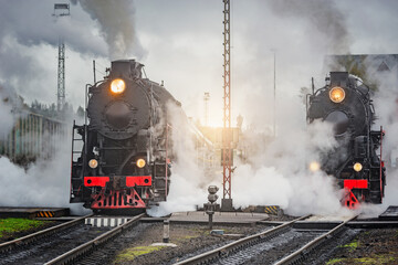 Retro steam trains stand by the platforms before departure. © serjiob74