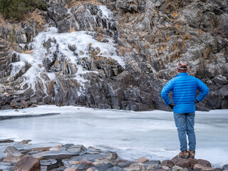 Naklejka premium male hiker in a canyon of mountain river in winter scenery - Poudre River at Little Narrow above Fort Collins, Colorado