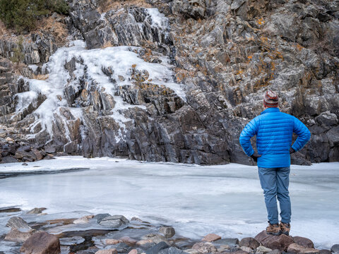 male hiker in a canyon of mountain river in winter scenery - Poudre River at Little Narrow above Fort Collins, Colorado