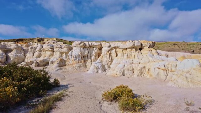 Panoramic view captures colorful badlands and white rock formations along the trail in Paint Mines Interpretive Park