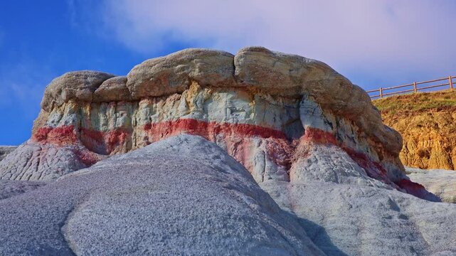 Colorful striped geological formations display vibrant clay layers in a close-up view at Paint Mines Interpretive Park