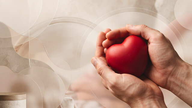 Close up of hands holding a red heart shape for love or charity