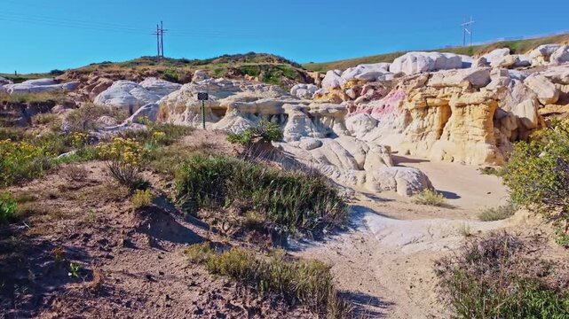 Vibrant pink and yellow geological formations rise at Paint Mines Interpretive Park in Calhan, Colorado