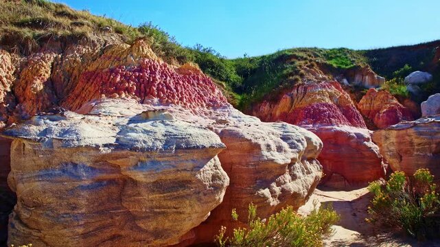 Vibrant pink and yellow geological formations rise at Paint Mines Interpretive Park in Calhan, Colorado