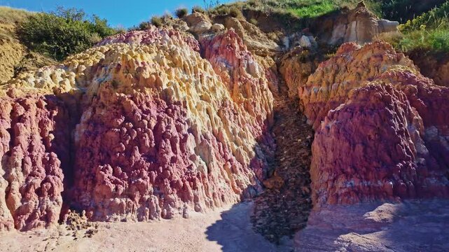 Vibrant pink and yellow geological formations rise at Paint Mines Interpretive Park in Calhan, Colorado