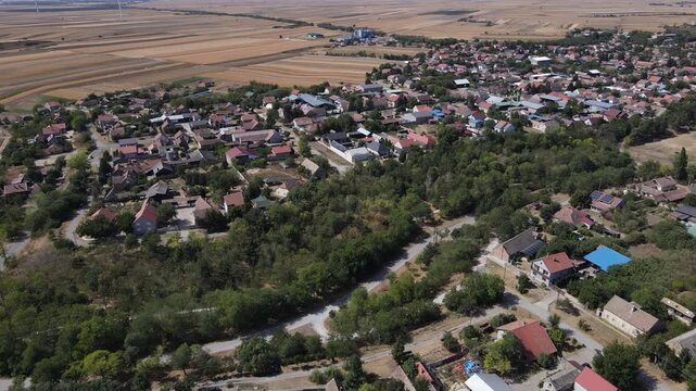 Drone aerial over Padina Serbia moving forward showing forest trial, houses and FK Dolina