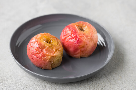 Baked sweet aples. On a plate. Light background. Close up