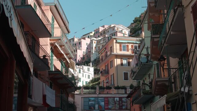 Colorful Hillside Buildings With Balconies Rise Above Narrow Street in Manarola