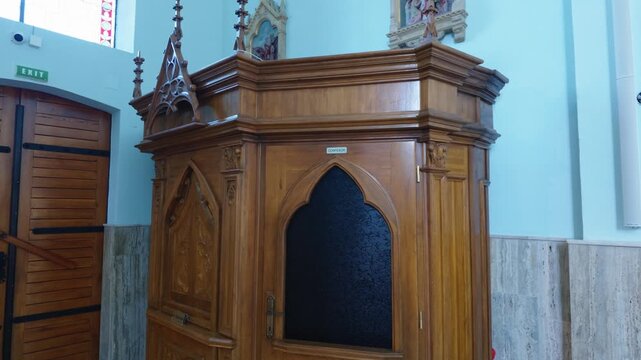 Detailed view of an ornate wooden religious structure inside a traditional church in Cacica, Romania.