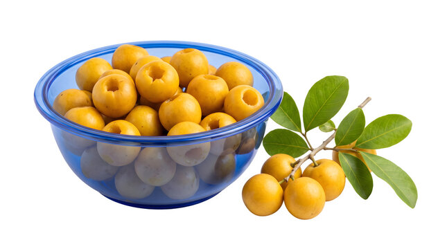 Fresh yellow nance fruits in a blue glass bowl with a leafy branch isolated on black background