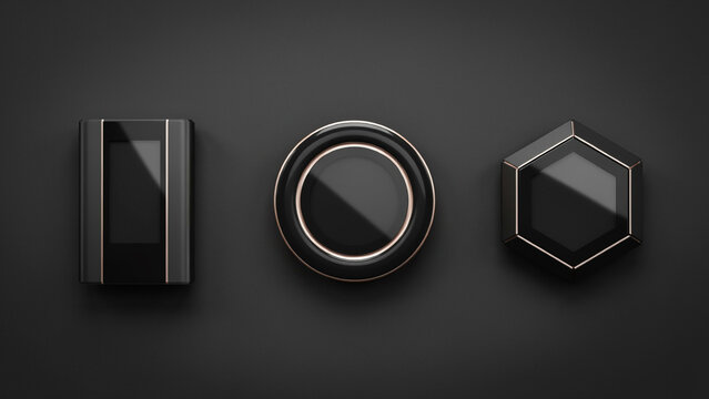 Three minimalist black with metallic gold trim including a rectangular device, a circular frame, and a hexagonal piece on a dark surface