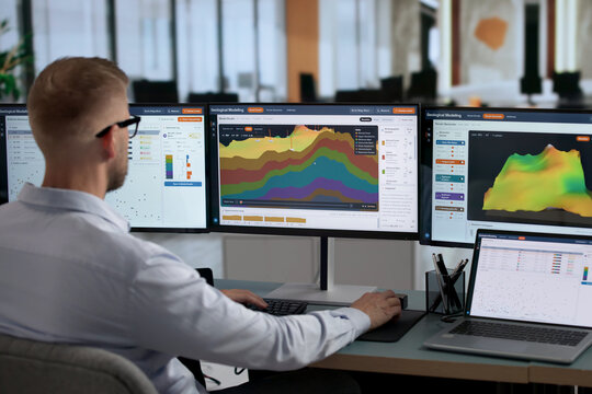 Geologist Studies 3D Subsurface Models On Laptop