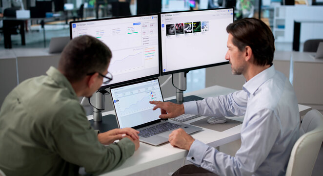 Marketing Manager Studies Campaign Data On Laptop