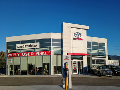 Penticton, Canada - June 22, 2026: The exterior of a Toyota dealership in Penticton Canada shows several vehicles for sale. The brand logo is visible on the building.