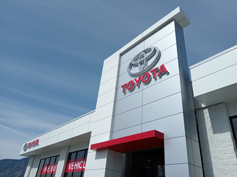 Penticton, Canada - June 22, 2026: The exterior of a Toyota dealership in Penticton Canada shows several vehicles for sale. The brand logo is visible on the building.