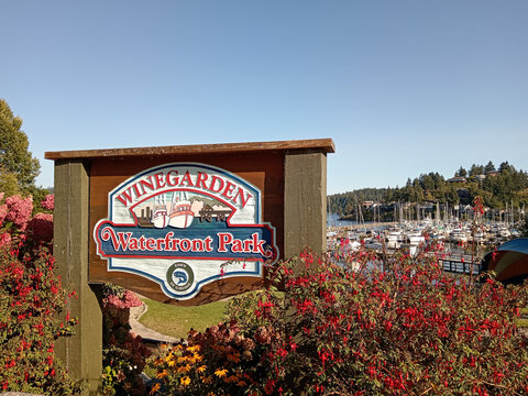 Gibsons, Canada - September 8, 2026: Winegarden Waterfront Park signage is seen in Gibsons, British Columbia, Canada with boats in the harbor.