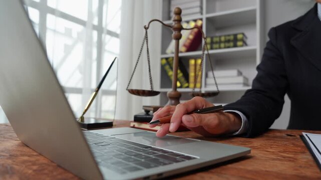 Female lawyer using laptop computer at desk in law office
