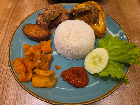 Traditional Indonesian Nasi Guged Jogja, sweet jackfruit stew with steamed rice and side dishes