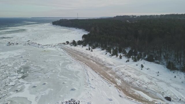 Top down aerial drone view of broken sea ice floes and frozen water texture