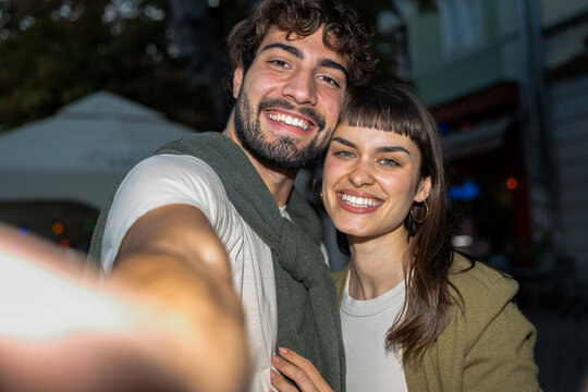 Young couple capturing a joyful moment together with a selfie