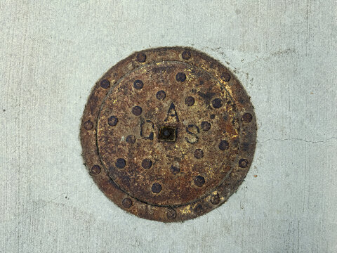 Gas valve cover plate in the concrete street pavement