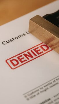 Customs declaration document marked with a bold red DENIED stamp, indicating a refusal or rejection during the process