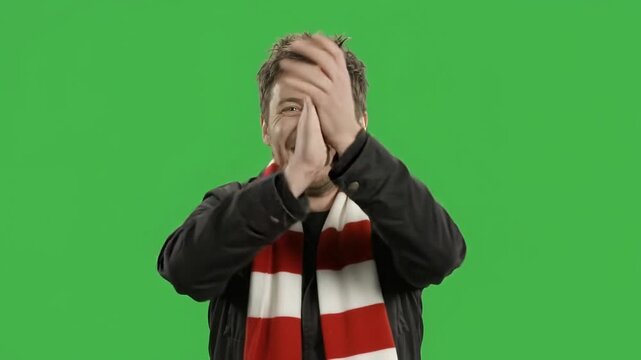 Football supporter cheering with scarf on green screen background