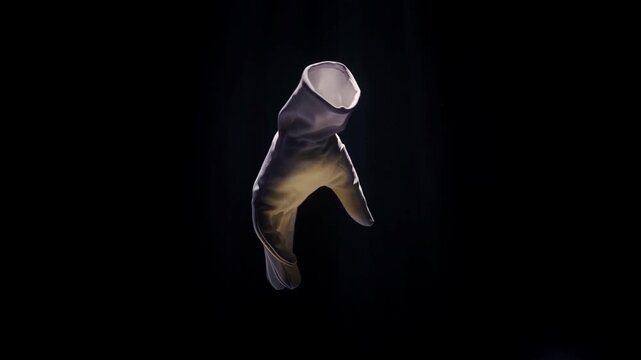 White Glove Suspended in Darkness with Dramatic Spotlight Highlighting Texture and Form for Luxury or Mystery Concept