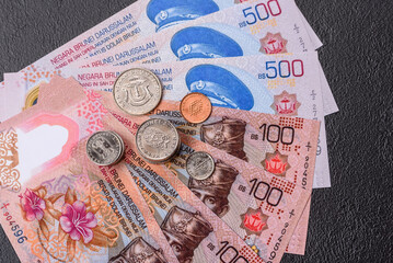 Brunei paper money, dollar banknotes and sen coins as currency for exchange or travel. Brunei money © chernikovatv