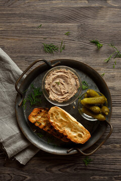 Liver pate served with toasted bread and marinated cucumber