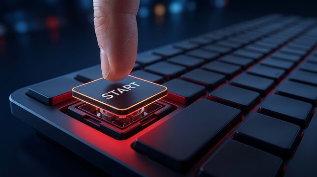 Human index finger pressing illuminated start key on modern black computer keyboard to initiate digital process or software application launch in dark office setting with shallow depth field