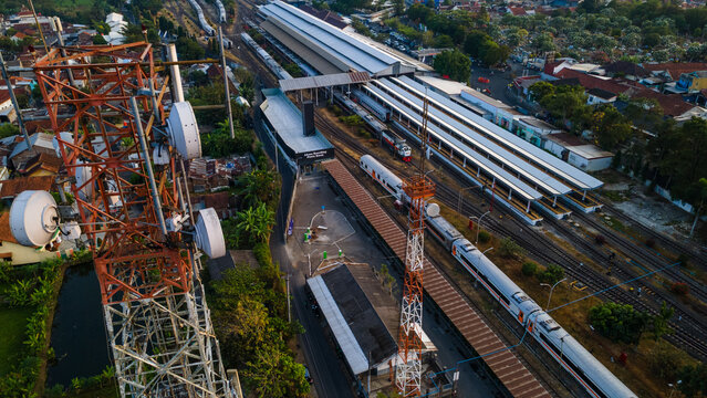 Aerial View of Telecommunication Tower with Radio Masts and Equipment Near a Railway Station in the Morning in Purwokerto, Central Java, Indonesia.