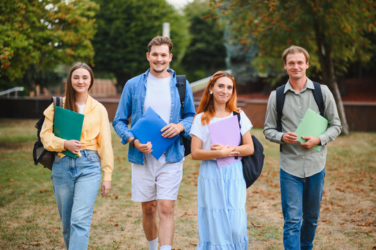 Group of students walking on university campus together