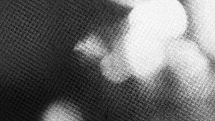 Naklejka premium Abstract dark grayscale grain texture featuring soft white light gradients and atmospheric shadows, ideal for modern background