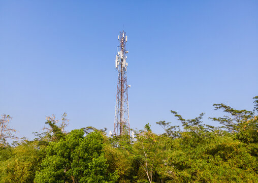 Aerial View of a Telecommunication Tower with Radio Masts and Equipment Surrounded by Trees in Purwokerto, Central Java, Indonesia.
