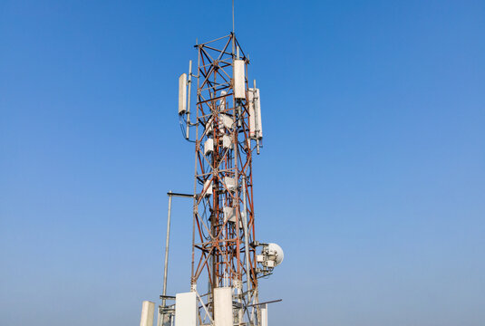Aerial View of a Telecommunication Tower with Radio Masts and Equipment Near a Retail Warehouse in the Morning in Purwokerto, Central Java, Indonesia.