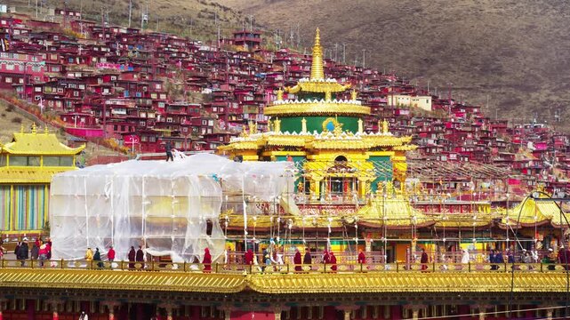 Aerial View of Tibetan Buddhist Monastery with Golden Temples and Red Houses in Sichuan, China in Seda Larung Gar Buddhist Academy, Sichuan, China