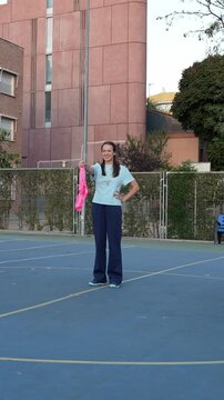 Two multiracial children, a boy and a girl, playing an active game of capture the flag with their female teacher in the schoolyard