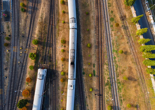 Aerial Top-Down View of Passenger Train Carriages Lined Up at Purwokerto Railway Station in the Morning, Central Java, Indonesia.