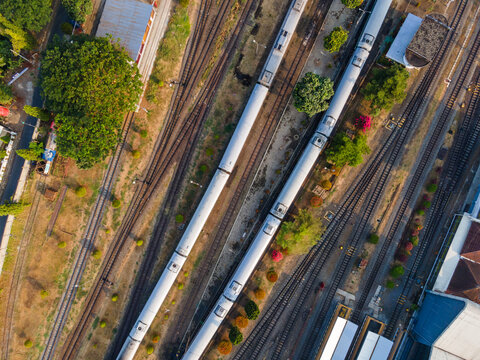 Aerial Top-Down View of Passenger Train Carriages Lined Up at Purwokerto Railway Station in the Morning, Central Java, Indonesia.