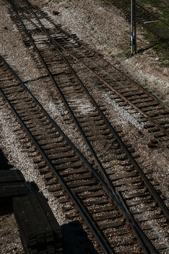 Top view of railway tracks junction and switch with gravel ballast &ndash; ideal for choices concept, logistics industry, travel directions, and infrastructure layout