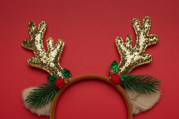 Festive Reindeer Antler Headband on Red Background: Christmas Holiday Decor © kvladimirv