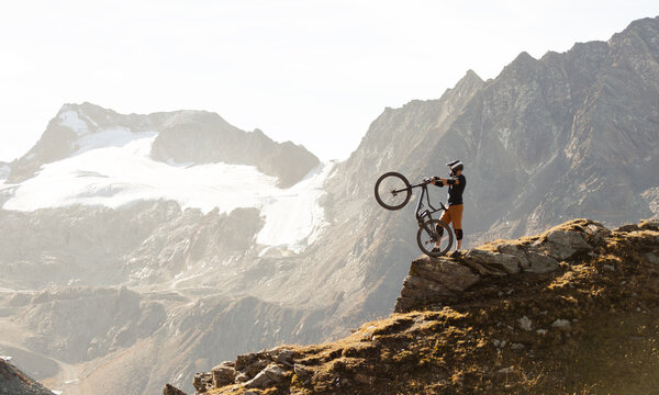Mountain Biker Posing Below an Alpine Glacier