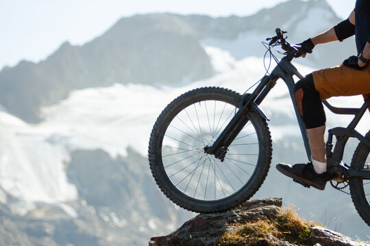 Mountain Biker Posing Below an Alpine Glacier