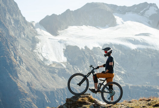 Mountain Biker Posing Below an Alpine Glacier