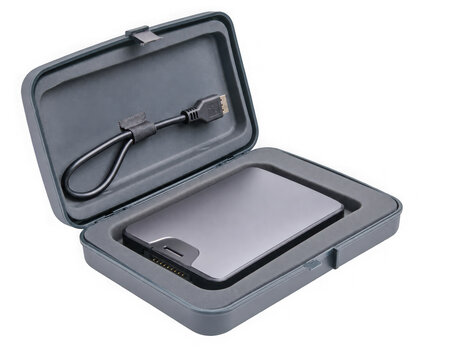 Portable external hard drive in a protective grey case with a usb cable, isolated on transparent background