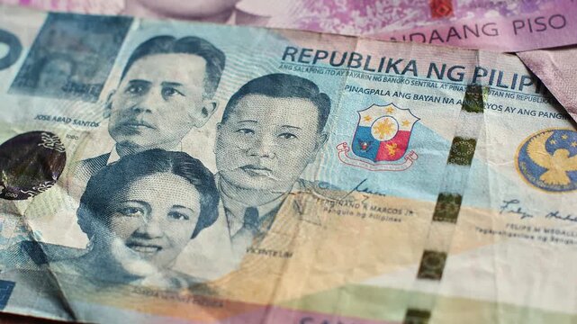Philippine national currency peso banknotes (PHP) of different denomination, close-up view footage. Cash money, financial income and growth, business concept