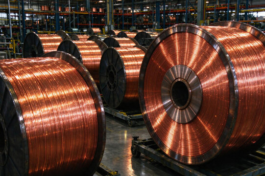 Spools of shiny copper wire in a cable factory